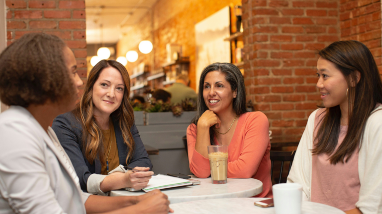 diverse background ladies talking coffee